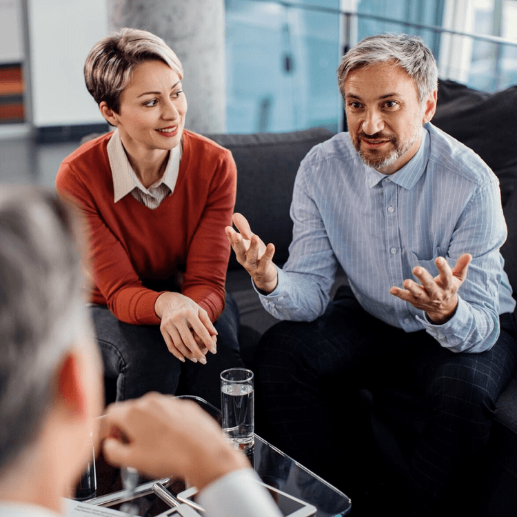 Two men and a woman are talking